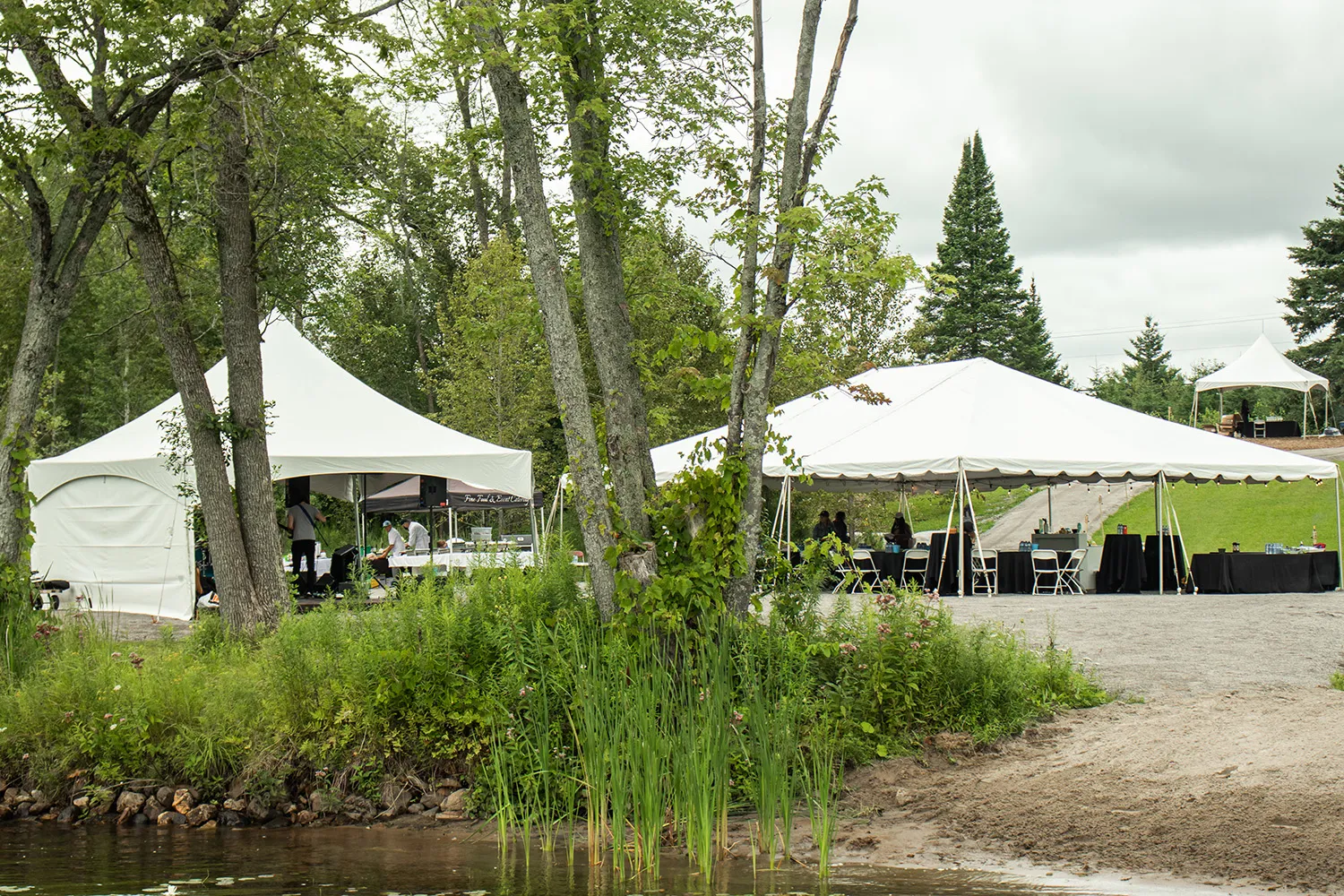 An event tent among trees on the resort grounds.